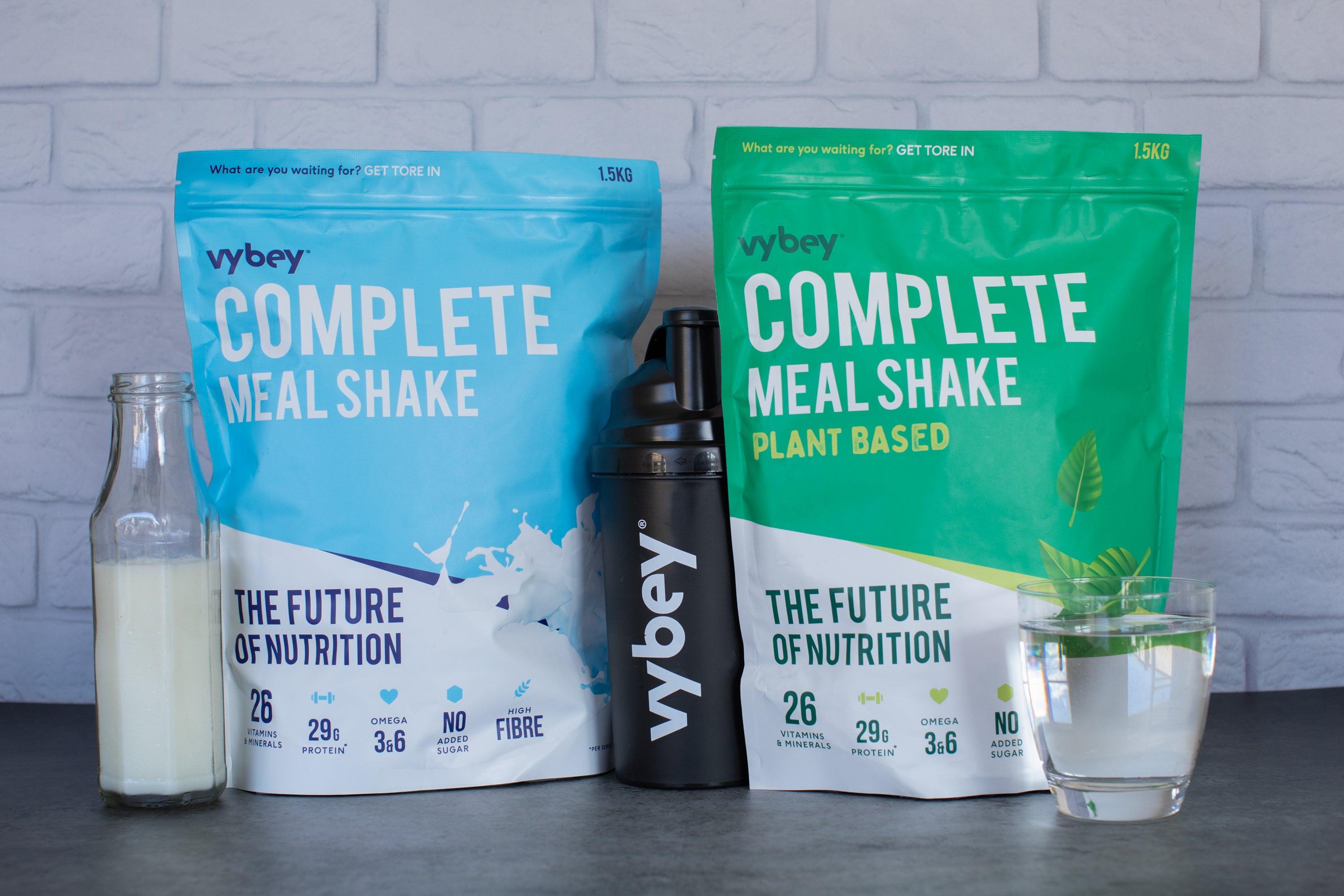 picture of vybey meal replacement australia vanilla and chcolate flavour with some milk bottle & glass of water