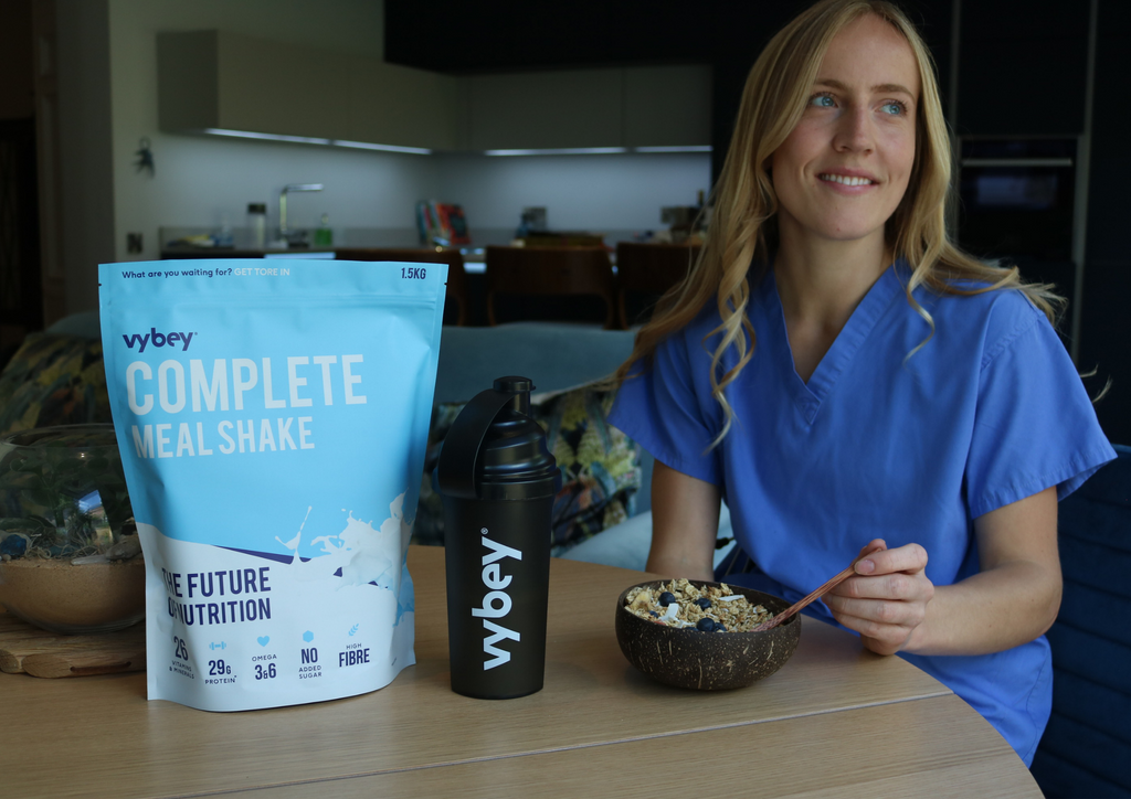 image of a doctor having vybey meal replacement shake with her granola making it a high protein and complete meal shake